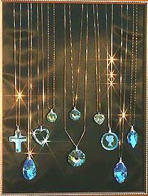 Display of Crystal Pendants on Gold Chains Sparkling in Sunlight